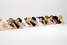 the group of young people are posing together for a photo in front of a white background