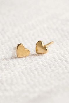 Tiny Gold Heart Stud Earrings - 4mm by Wild Moonstone | Jewelry with purpose | based in Northern California | making Jewelry for you and the people you love. Absolutely adorable, comfortable and solid gold. They are perfect for anyone that loves dainty studs. Shop the collection! stud earrings, heart stud earrings, gold heart stud earrings, gold jewelry, mini stud earrings, mini gold heart earrings, minimalist earrings, minimalist jewelry, everyday wear jewelry, gold jewelry gift Gold Heart Earrings In Minimalist Style, Dainty Tiny Gold Heart Earrings, Gold Minimalist Heart Earrings For Everyday, Minimalist Gold Hypoallergenic Heart Earrings, Dainty Round Heart Earrings For Everyday, Delicate Gold Heart Earrings For Everyday, Dainty Yellow Gold Heart Earrings For Everyday Wear, Tiny Dainty Yellow Gold Heart Earrings, Everyday 14k Gold Hypoallergenic Heart Earrings