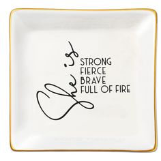 a white and yellow plate with black writing on the side that says, strong fierce brave full of fire