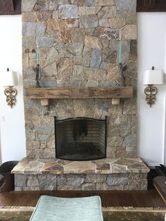 a living room with a stone fireplace in it