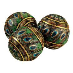 three decorative balls with peacock feathers on them