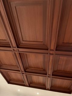 the ceiling in this kitchen is made of wood and has many recessed panels on it