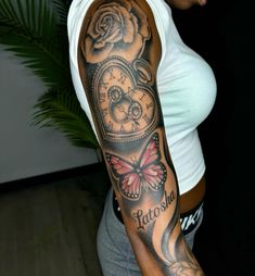 a woman with a clock and rose tattoo on her arm