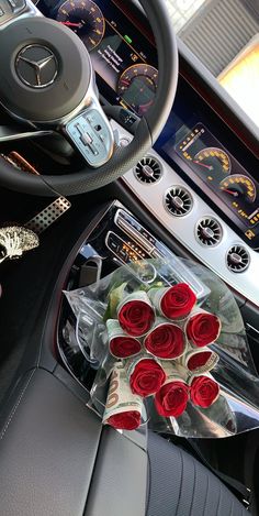 the interior of a car with red roses on the steering wheel and dash stickers