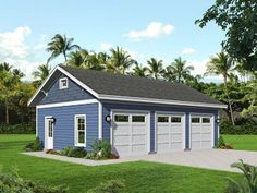 a blue and white garage sitting in the middle of a lush green field with palm trees