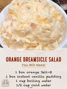 an orange creamsice salad in a white bowl on a wooden table with instructions for how to make it