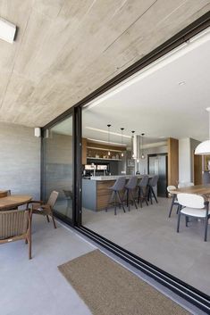 an open living room and dining area with sliding glass doors