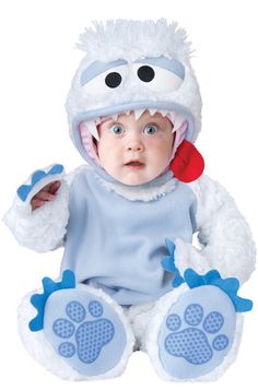 a baby dressed in a costume that looks like a monster with big eyes and paws