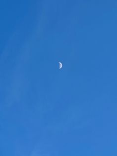 the moon is in the clear blue sky