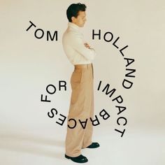 a man standing with his arms crossed in front of the words tom holland for imba place