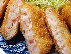 some fried food on a blue and white plate with lettuce in the middle