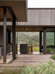 an outdoor dining area with wooden flooring and sliding glass doors