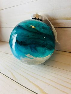 a glass ornament sitting on top of a wooden table next to a wall