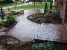 an outdoor patio with stone steps and landscaping