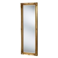 a gold framed mirror sitting on top of a white wall