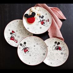 three plates with mickey mouse designs on them next to a red and white bow tie