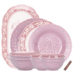 pink dinnerware set with ornate design on the front and side dishes in the back