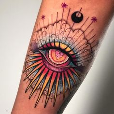 an eye tattoo on the arm with stars and lines coming out of its irise