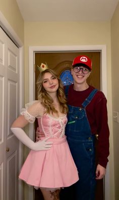 two people dressed up in costumes posing for the camera