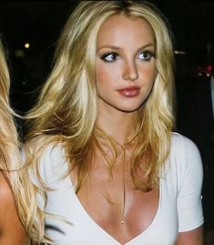 two beautiful blonde women standing next to each other