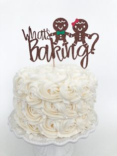 a close up of a cake on a plate with a sign that says what's baking?