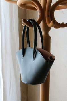 Genuine Mango Vegan leather bucket bag in deep evergreen.

This purse features a structured exterior body with zip closure cotton interior compartment.

Can be carried as a handbag or worn as a shoulder or crossbody with the included strap!

Like new condition. There is minor wear on d-ring hardware where the optional strap attaches. Modern Bucket Bag With Handles For Errands, Modern Bucket Satchel With Handles, Green Bucket Bag With Adjustable Strap And Top Handle, Bucket Shoulder Bag With Handle Drop For Errands, Green Bucket Bag With Detachable Handle, Green Bucket Bag With Detachable Strap And Double Handle, Green Top Handle Bucket Bag For Travel, Bucket Satchel With Detachable Handle For Daily Use, Green Top Handle Bucket Bag