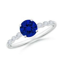 a blue sapphire and diamond ring on a white background