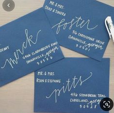 three blue envelopes with white calligraphy on them