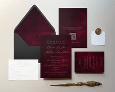 the wedding stationery is laid out neatly on top of each other, including two envelopes and a pair of scissors