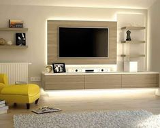 a modern living room with white walls and yellow furniture in front of a flat screen tv