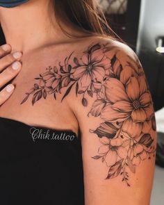 a woman's shoulder with flowers on it