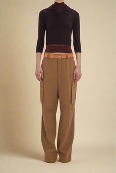 One of Victoria’s collection highlights, these loose-fitting cargo trousers bring the military-inspired style up to date with the house’s signature elevated detailing. Tailored from 100% cotton, they have a modern relaxed silhouette with traditional five-loop waistband and pockets at the side of each leg. Contrasting red bar tacks on the left back pocket flap, white stitching on the right back welt pocket and dart details at the front knee of both legs add visual interest. Loose fitting trouser Red Bar, Mood Indigo, Eyewear Shop, Cargo Style, Military Inspired, Cargo Trousers, Fitted Silhouette, Contrast Stitch, Up To Date