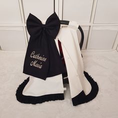 a black and white bow tie sitting on top of a chair