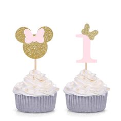 two cupcakes with minnie mouse toppers on them, one is pink and the other is gold