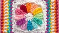 a crocheted square with multicolored flowers on it