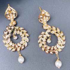 Featuring a pair of jadau earrings that are perfect for any occasion. Made in 22ct gold and embellished with finest freshwater pearls. These unique earrings feature the perfect balance of contemporary style and timeless elegance, making them the perfect gift or sentiment for any special occasion. The earrings weigh 12.04 GMs including 0.57 GMs of hanging pearl drops Elegant Kundan Pearl Drop Earrings, Elegant Pearl Meenakari Earrings For Diwali, Elegant White Kundan Earrings, Elegant Hand-set Pearl Earrings, Elegant Kundan Pearl Earrings, Elegant Gold-plated Meenakari Pearl Earrings, Elegant Meenakari Gold-plated Pearl Earrings, Elegant Kundan Pearl Earrings For Celebration, White Chandbali Pearl Earrings For Formal Occasions