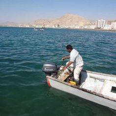 a man on a small boat in the water