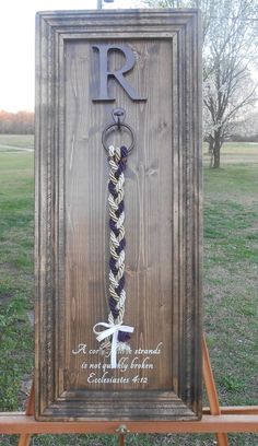 a wooden sign with a rope on it