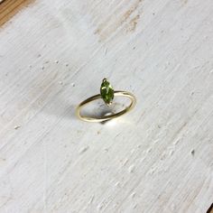 Green Peridot Birthstone Ring With Prong Setting, Green Marquise 14k Gold Ring, Green Marquise Ring In 14k Gold, Marquise Green Ring In 14k Gold, Green Marquise 14k Gold Jewelry, Yellow Gold Peridot Diamond Ring With Birthstone, Peridot Birthstone Diamond Ring Fine Jewelry, Green Peridot Stackable Promise Rings, Green Peridot Birthstone Ring