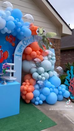 an under the sea themed birthday party with balloons and streamers in front of a house