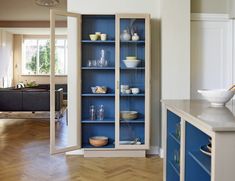 an open bookcase in the middle of a room