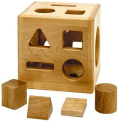 a wooden block set with four pieces and one piece cut out to look like an object