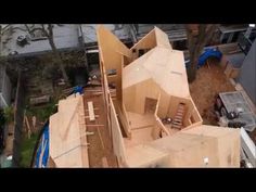 an aerial view of a house being built in the middle of a yard with lots of wood