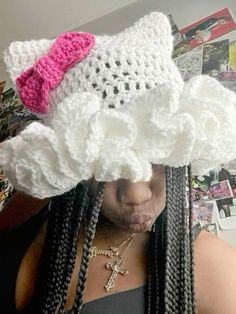 a woman with braids wearing a crochet hat