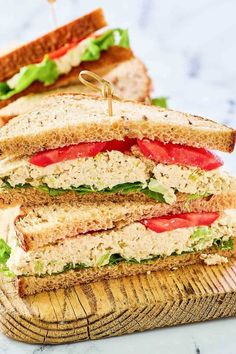 a cut in half sandwich sitting on top of a cutting board