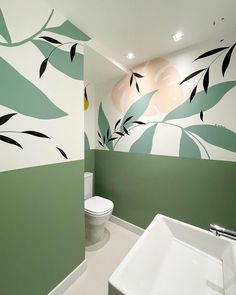 a bathroom with green and white paint on the walls