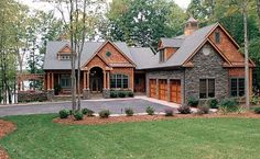 a large stone and wood house in the woods