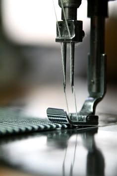 the sewing machine is being used to sew on fabric or other material that has been stitched together