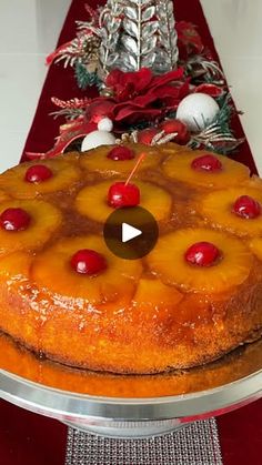 a pineapple upside down cake with cherries on the top and red table runner