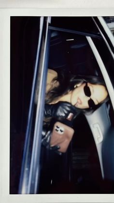 a woman is sitting in the passenger seat of a car